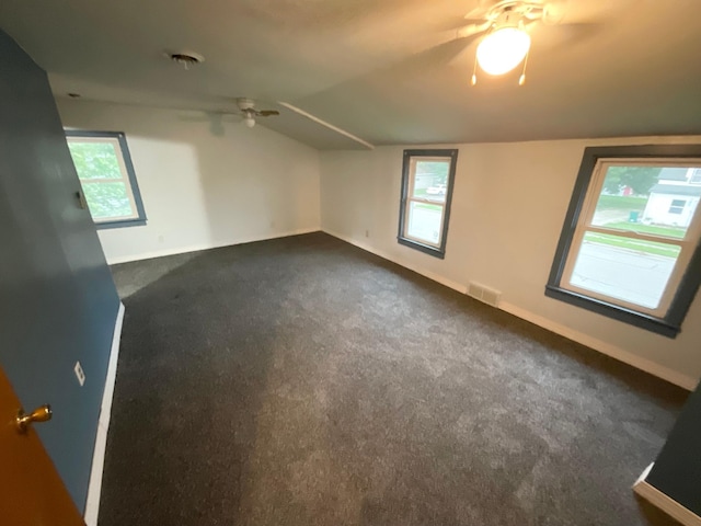 108 Johnson St NE, Brownsdale, MN 55918 - bonus room featuring a ceiling fan, lofted ceiling, and dark carpet