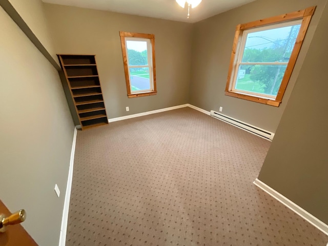 108 Johnson St NE, Brownsdale, MN 55918 - spare room with a baseboard heating unit and carpet