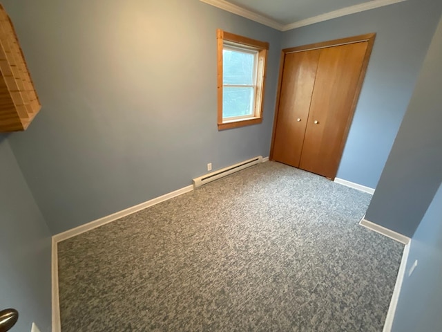 108 Johnson St NE, Brownsdale, MN 55918 - unfurnished bedroom featuring a baseboard heating unit, carpet flooring, ornamental molding, and a closet