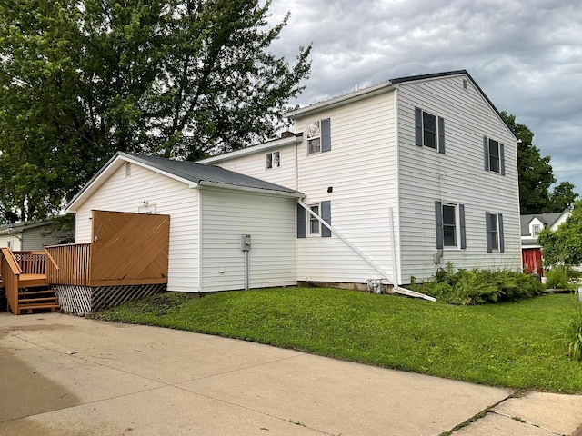 108 Johnson St NE, Brownsdale, MN 55918 - view of property exterior with a wooden deck, a lawn, and a metal roof