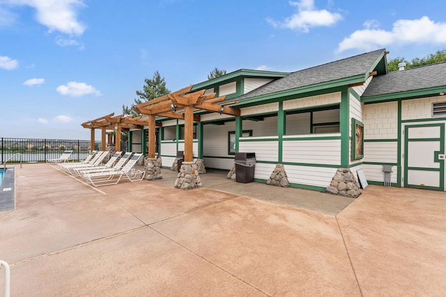 15588 Early Bird Cir Unit 1704, Apple Valley, MN 55124 - view of front facade with a pergola, a patio area, roof with shingles, and a water view