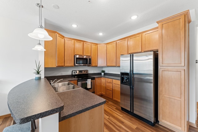 15588 Early Bird Cir Unit 1704, Apple Valley, MN 55124 - kitchen featuring appliances with stainless steel finishes, a peninsula, dark countertops, light wood-style floors, and recessed lighting