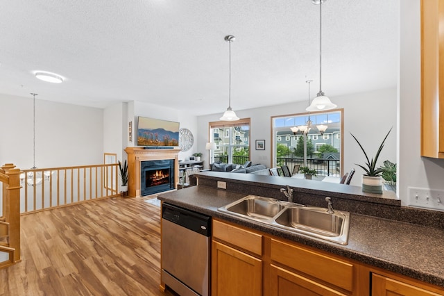 15588 Early Bird Cir Unit 1704, Apple Valley, MN 55124 - kitchen featuring stainless steel dishwasher, light wood finished floors, dark countertops, a textured ceiling, and hanging light fixtures
