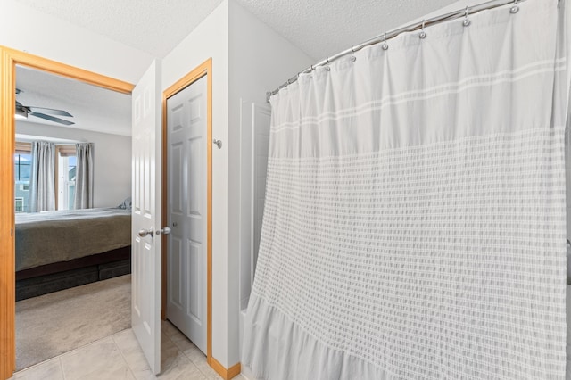 15588 Early Bird Cir Unit 1704, Apple Valley, MN 55124 - bathroom featuring ensuite bathroom, a textured ceiling, tile patterned flooring, a ceiling fan, and a shower with curtain