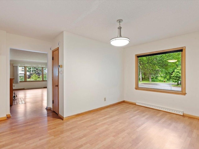 517 Cedar St, Brainerd, MN 56401 - empty room featuring baseboard heating and light wood finished floors
