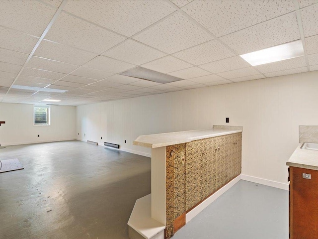 517 Cedar St, Brainerd, MN 56401 - basement featuring a paneled ceiling and a baseboard radiator