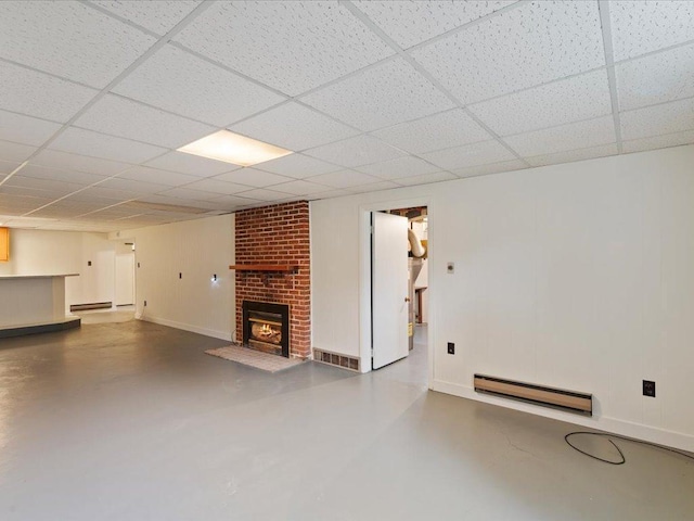 517 Cedar St, Brainerd, MN 56401 - unfurnished living room with a baseboard heating unit, concrete floors, a fireplace, a paneled ceiling, and baseboard heating