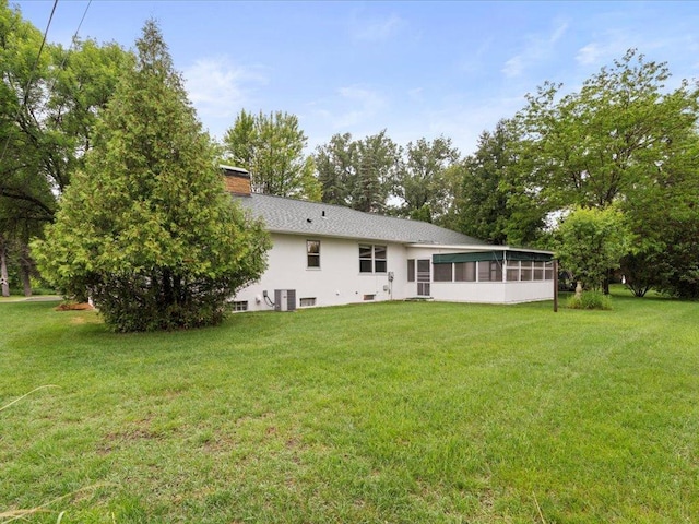 517 Cedar St, Brainerd, MN 56401 - back of property with a sunroom, a lawn, and a chimney