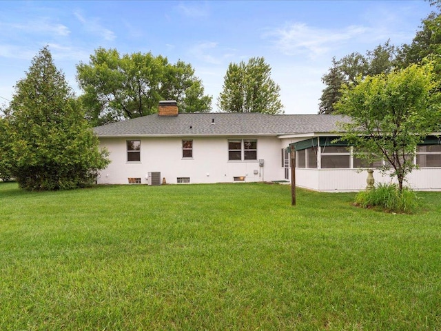 517 Cedar St, Brainerd, MN 56401 - rear view of property with a sunroom, a yard, a chimney, and stucco siding