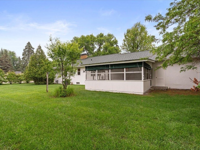 517 Cedar St, Brainerd, MN 56401 - back of house featuring a sunroom and a lawn