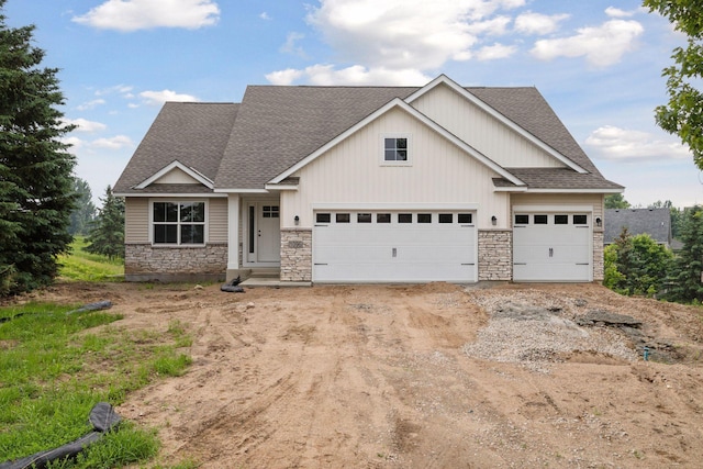1096 Prospect Pointe Rd, Jordan, MN 55352 - craftsman house featuring a shingled roof, stone siding, a garage, and dirt driveway