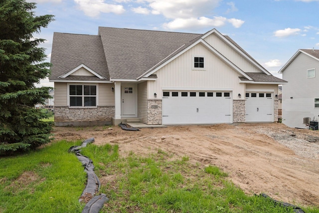 1096 Prospect Pointe Rd, Jordan, MN 55352 - craftsman-style house with stone siding, a shingled roof, a garage, and dirt driveway