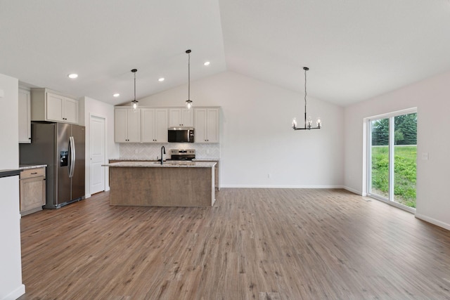 1096 Prospect Pointe Rd, Jordan, MN 55352 - kitchen featuring appliances with stainless steel finishes, backsplash, wood finished floors, a chandelier, and a center island with sink