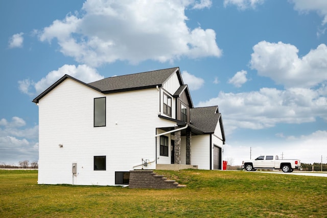 1205 Skyview Cir NW, Rochester, MN 55901 - rear view of property featuring a lawn, a garage, and roof with shingles