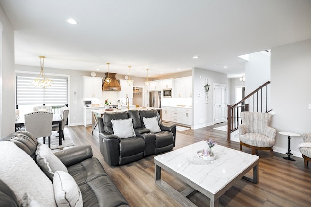 1205 Skyview Cir NW, Rochester, MN 55901 - living area featuring dark wood-style floors, a chandelier, recessed lighting, and stairs