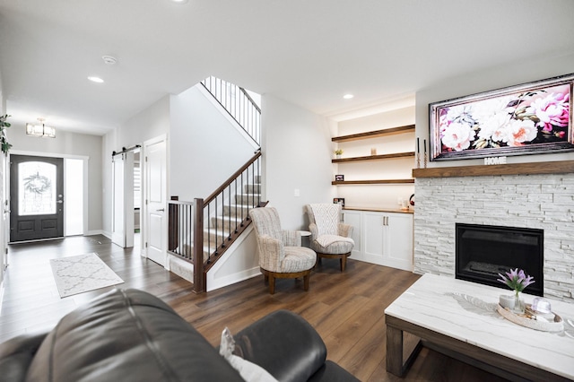 1205 Skyview Cir NW, Rochester, MN 55901 - living area with a barn door, dark wood-type flooring, stairs, recessed lighting, and a stone fireplace