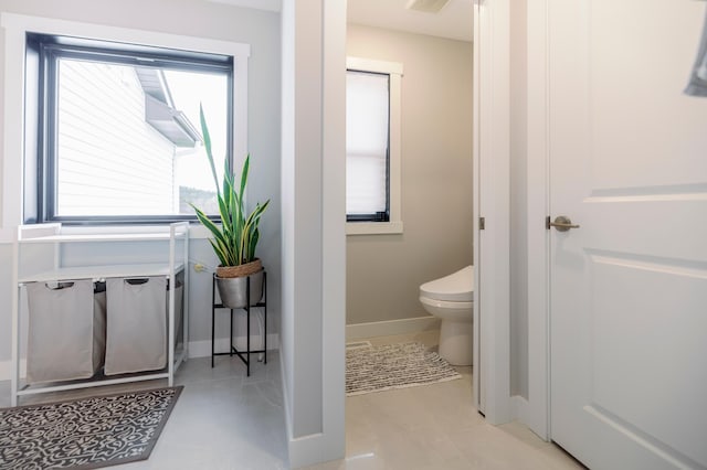 1205 Skyview Cir NW, Rochester, MN 55901 - bathroom featuring toilet and baseboards