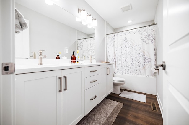 1205 Skyview Cir NW, Rochester, MN 55901 - bathroom featuring double vanity, wood finished floors, shower / bath combo with shower curtain, and recessed lighting