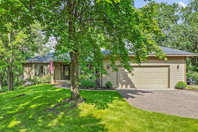 13790 Crane St NW, Andover, MN 55304 - view of property hidden behind natural elements featuring asphalt driveway, a front yard, roof with shingles, and an attached garage