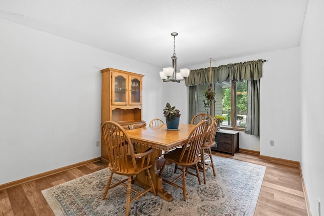 13790 Crane St NW, Andover, MN 55304 - dining space with a chandelier and light wood-style flooring