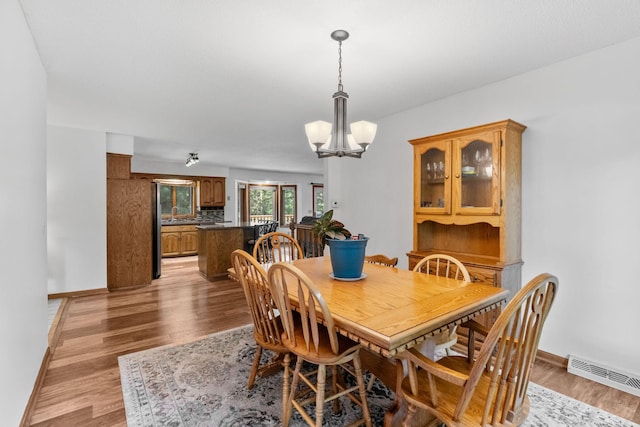 13790 Crane St NW, Andover, MN 55304 - dining room with a chandelier and light wood finished floors