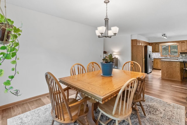 13790 Crane St NW, Andover, MN 55304 - dining area with a chandelier and light wood-style floors