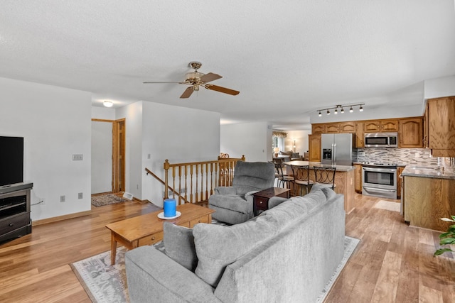 13790 Crane St NW, Andover, MN 55304 - living area with a ceiling fan, light wood-style floors, and a textured ceiling