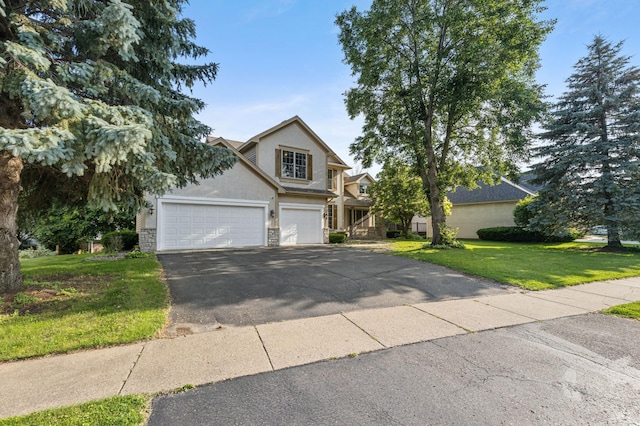 13845 Essex Trl, Apple Valley, MN 55124 - view of front facade with driveway, a front yard, stucco siding, and stone siding
