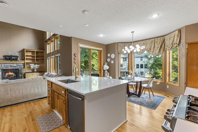 13845 Essex Trl, Apple Valley, MN 55124 - kitchen featuring stainless steel dishwasher, a textured ceiling, light wood-type flooring, a chandelier, and decorative light fixtures
