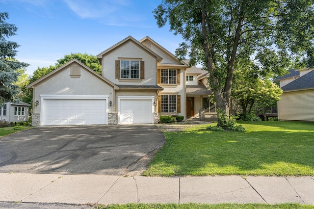 13845 Essex Trl, Apple Valley, MN 55124 - traditional-style home featuring stone siding, asphalt driveway, stucco siding, and a front lawn