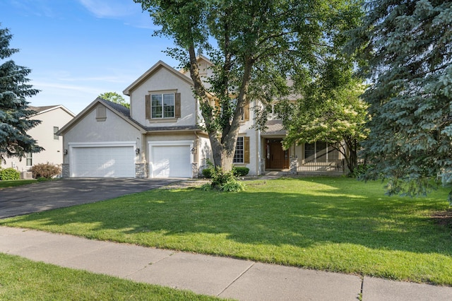 13845 Essex Trl, Apple Valley, MN 55124 - traditional-style home featuring stucco siding, asphalt driveway, an attached garage, and a front yard
