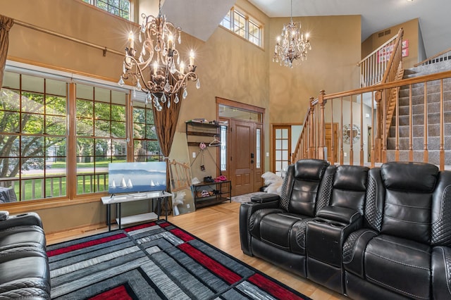 13845 Essex Trl, Apple Valley, MN 55124 - living area with a chandelier, plenty of natural light, a high ceiling, wood finished floors, and stairs