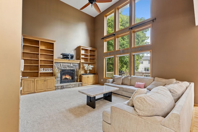 13845 Essex Trl, Apple Valley, MN 55124 - living area with high vaulted ceiling, a ceiling fan, a fireplace, and carpet floors