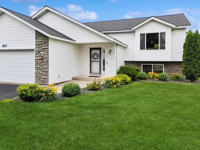853 Texas Ct NW, Hutchinson, MN 55350 - tri-level home featuring stone siding, a garage, and a shingled roof
