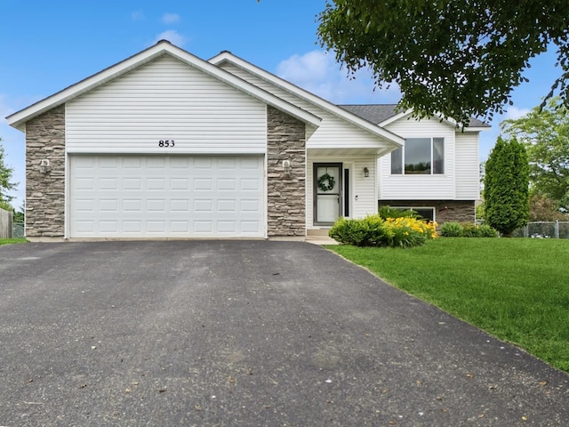 853 Texas Ct NW, Hutchinson, MN 55350 - view of front of property featuring stone siding, asphalt driveway, a front lawn, and an attached garage