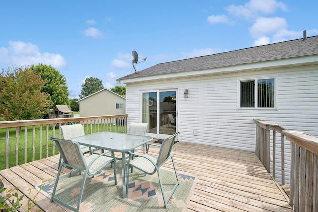 853 Texas Ct NW, Hutchinson, MN 55350 - wooden terrace featuring outdoor dining area and a lawn