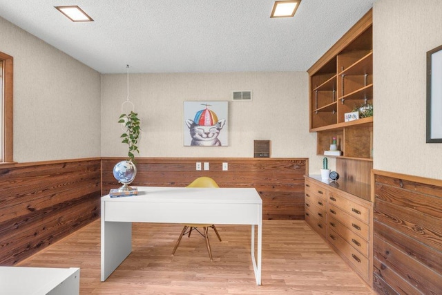 237 Campbell Dr, Hopkins, MN 55343 - office area featuring light wood-style floors, a textured ceiling, and wooden walls