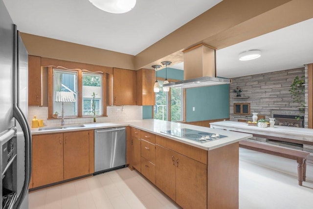 237 Campbell Dr, Hopkins, MN 55343 - kitchen featuring appliances with stainless steel finishes, light countertops, a peninsula, and tasteful backsplash