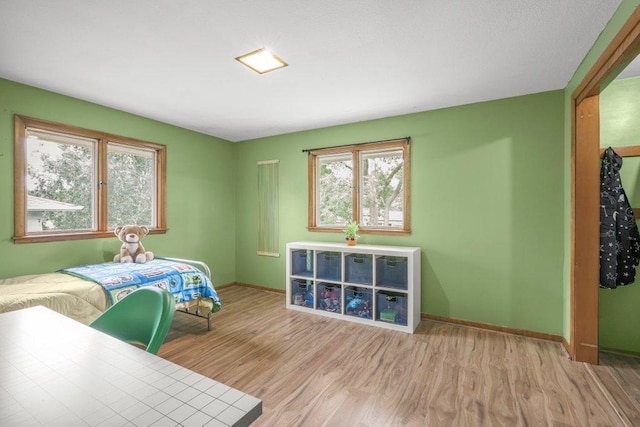 237 Campbell Dr, Hopkins, MN 55343 - bedroom featuring multiple windows and wood finished floors