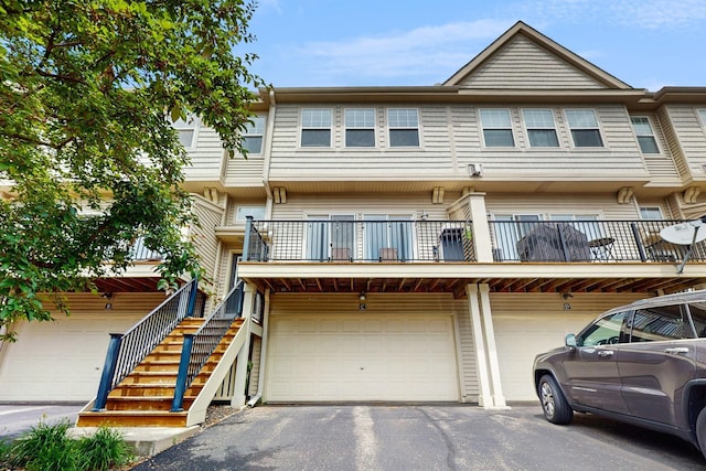 2408 121st Cir NE Unit C, Blaine, MN 55449 - view of property featuring an attached garage, driveway, and a balcony
