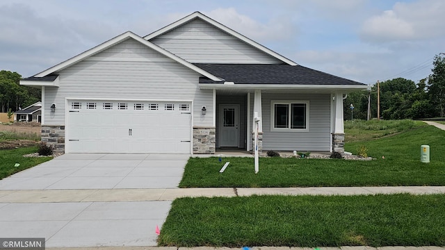 3104 Zuni St, Anoka, MN 55303 - view of front of property with a front yard, covered porch, stone siding, driveway, and a garage