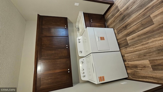 3104 Zuni St, Anoka, MN 55303 - kitchen featuring stacked washer / drying machine, a textured wall, and dark brown cabinets