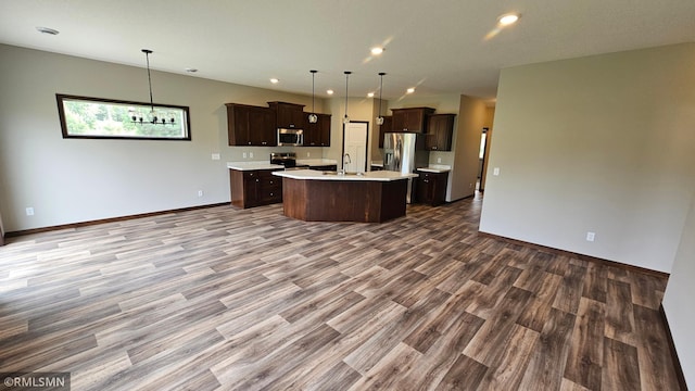 3104 Zuni St, Anoka, MN 55303 - kitchen featuring appliances with stainless steel finishes, open floor plan, light countertops, wood finished floors, and dark brown cabinets