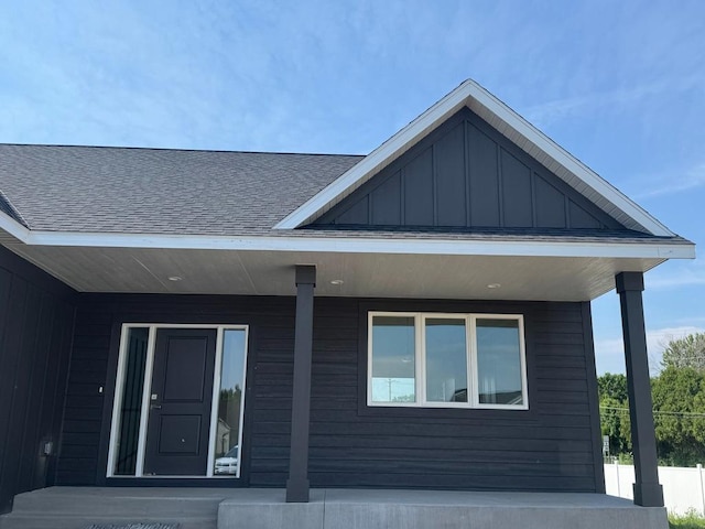 1945 Spruce Meadows Dr SE, Rochester, MN 55904 - view of side of home with board and batten siding, a porch, and roof with shingles