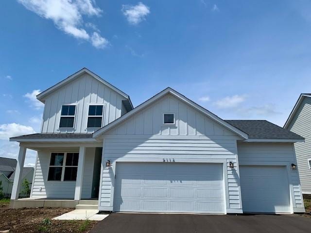 5112 Airlake Dr, Woodbury, MN 55129 - view of front facade with a porch, a garage, and board and batten siding