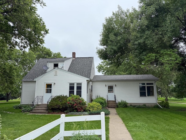 31678 Liberty Ave, Redwood Falls, MN 56283 - back of property featuring entry steps, a chimney, a lawn, and roof with shingles