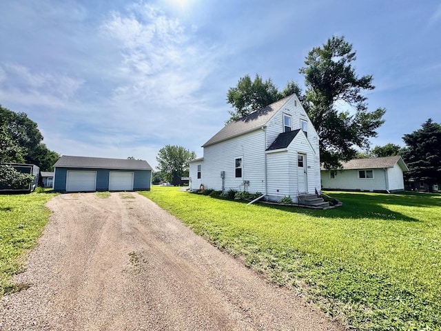 420 7th St, Marshall, MN 56258 - view of side of home featuring an outdoor structure, a garage, driveway, and a lawn