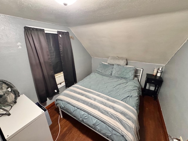420 7th St, Marshall, MN 56258 - bedroom with wood finished floors, lofted ceiling, and a textured ceiling