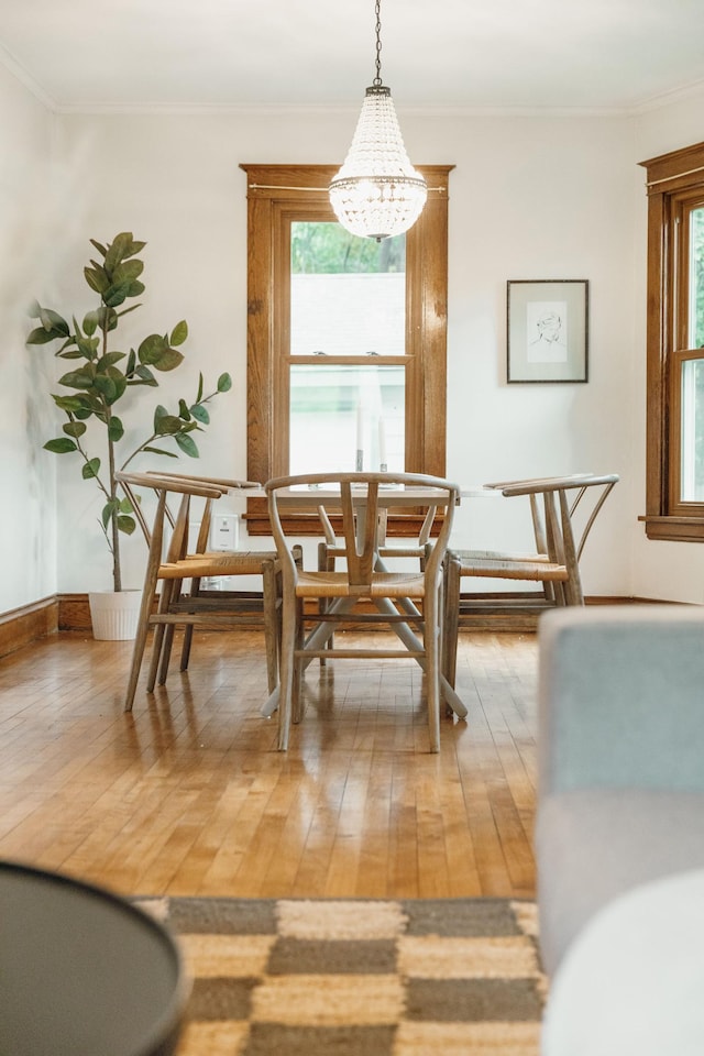 1112 29th Ave NE, Minneapolis, MN 55418 - dining space featuring a chandelier, light wood-style flooring, and ornamental molding
