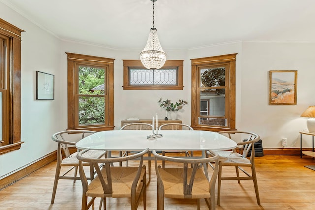 1112 29th Ave NE, Minneapolis, MN 55418 - dining space with a chandelier, light wood-style floors, and ornamental molding